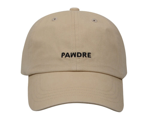 May include: A beige baseball cap with black stitching and the word 'PAWDRE' embroidered on the front in black.