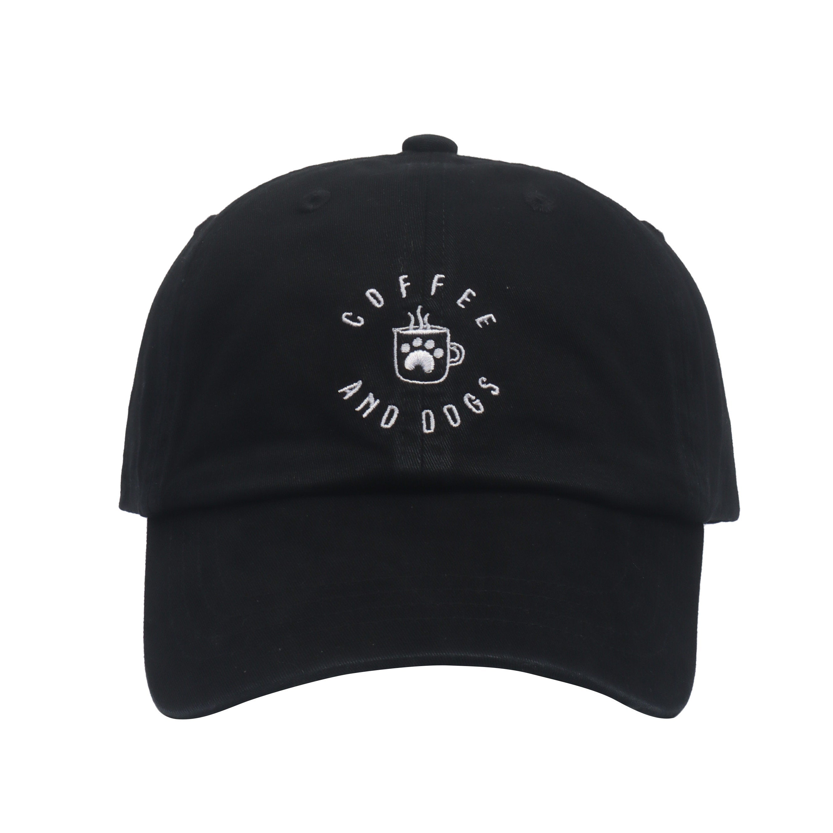 May include: A black baseball cap with a white embroidered design that says 'Coffee and Dogs' with a coffee cup and paw print in the center.